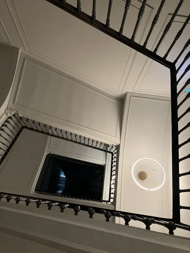 A hotel staircase in Turin from below.