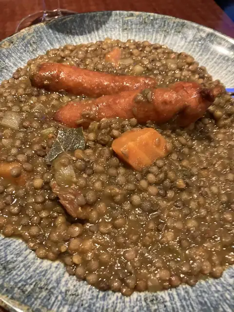 A delicious lentil stew with some smoked sausages floating